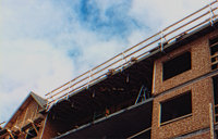 Homeowner waves from roof after installing the Genesis Safety System